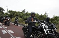 U.S. troops and members of the Okinawa American Legion cruise down Route 58 on their motorcycles.