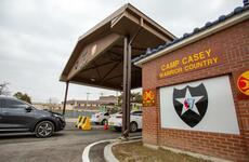 Vehicles line up to enter Camp Casey, South Korea, Feb. 26, 2020.