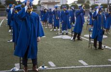 Yokota High School seniors move their tassels during a graduation ceremony at Yokota Air Base, Japan, Thursday, June 4, 2020.
