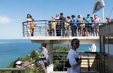 Tourists pose for pictures and walk around a Demilitarized Zone observatory near Goseong, South Korea, Saturday, Aug. 26, 2017.