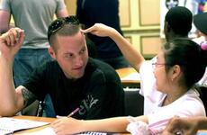 Park Hye-bin, right, shares a moment with Pvt. 2nd Class Matt Theilicker during the 2nd Infantry Division’s “Good Neighbor English Camp” on Thursday at Camp Casey, South Korea.