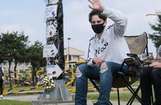 Humphreys High School senior Matthew Macy waves to his supporters during a reverse parade for soon-to-be graduates at Camp Humphreys, South Korea, Thursday, May 27, 2021.