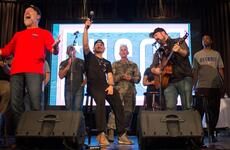 Gen. Paul Selva, vice chairman of the Joint Chiefs of Staff, sings with celebrities during a USO show at Osan Air Base, South Korea, Monday, April 23, 2018.