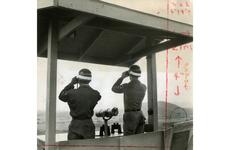 Two unidentified soldiers check for communist movements across the DMZ in North Korea at Outpost Maizie.