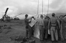 A Scout H-13 helicopter takes off during Operation White Wing at Bong Son. The helos refuel, and pilots get briefed on the operation at the LZ. 