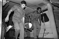 An unidentified burn victim is carried on a stretcher 