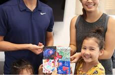 Marine Maj. Sam Wuornos, his wife, Christine, and daughters Evie, 7, and Ella, 4, show off a project they completed from a USO Family Activity Box at Camp Foster, Okinawa, Wednesday, Aug. 28, 2019.