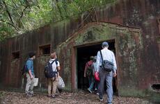 Japanese visitors tour a World War II-era munitions storage site at Tama Hills Recreation Area in western Tokyo, Wednesday, May 26, 2021.