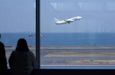 A flight takes off from Haneda International Airport in Tokyo, March 18, 2020.