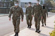 Sailors assigned to Sasebo Naval Base, Japan, wear face masks and practice social distancing while walking on base April 9, 2020.