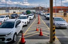 A stream of vehicles wait to enter the Dongchang-ri gate at Camp Humphreys, South Korea, Wednesday, Feb. 26, 2020, as soldiers screen visitors for the new coronavirus. 