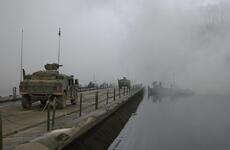 Military vehicles cross the Imjin River