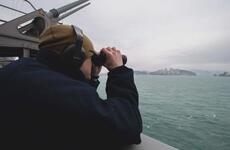 Petty Officer 2nd Class Thomas Gammon, of Georgetown, Texas, stands lookout aboard the aircraft carrier USS Carl Vinson as it pulls into Busan, South Korea, for a scheduled port visit, March 2, 2025.