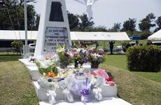 Flowers cover an marking the spot where Ernie Pyle was killed.