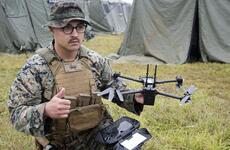 A Marine gives the all-clear for flight while demonstrating the Skydio X2D unmanned aircraft system.