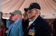 James Capers salutes during a ceremony.