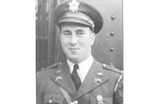 A black-and-white, 1940s-era image of a military officer, seen from the chest up, posing in dress uniform and hat.