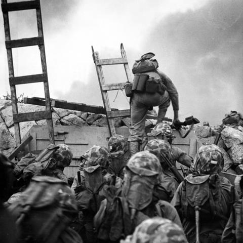 Marines climb over seawall during Incheon landing in Korean War