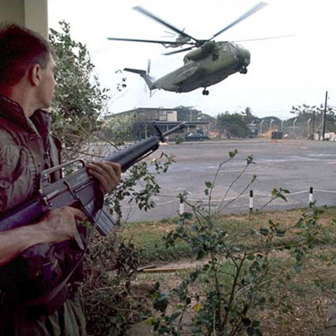 CH-53 helicopter landing and protected by soldier