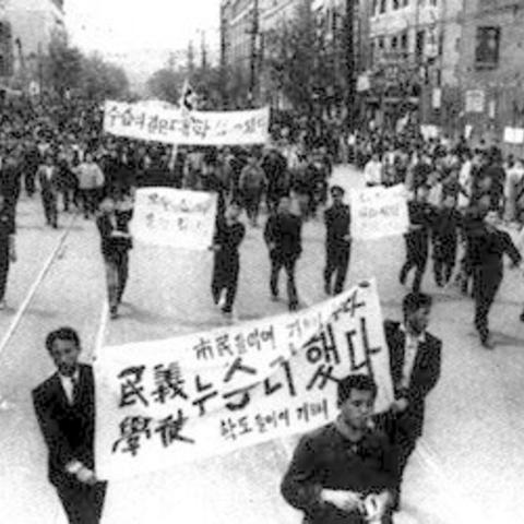 protesters in the street with signs
