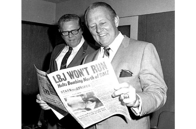During a visit to Stars and Stripes; Tokyo office on April 2, 1968, TV host Art Linkletter checks out a copy of the paper with a headline about President Lyndon Johnson's decision not to run for re-election.