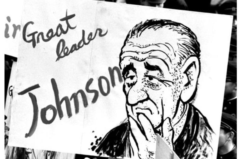 A sign welcoming Lyndon B. Johnson to Seoul is carried by students awaiting the president's arrival at City Hall Plaza.