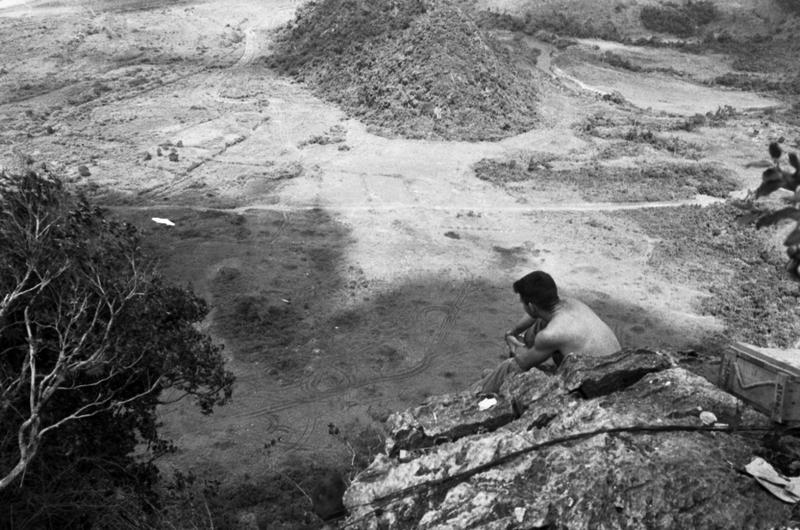 An unknown Marine looks out over a valley from his vantage point atop the Rockpile in November 1966.