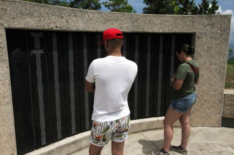 Members of the 3rd Marine Division read the names of the Marines who perished liberating Guam from Japanese control during World War II on a monument atop Nimitz Hill, Wednesday, July 18, 2018.