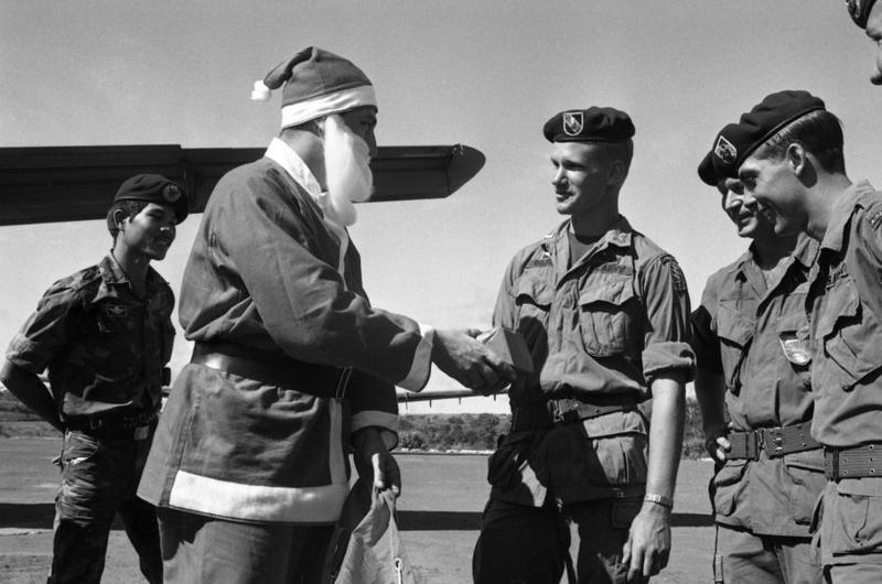 Santa Claus hands out presents to the men of Detachment 35, Company B, 5th Special Forces Group, in Vietnam at the end of 1968.