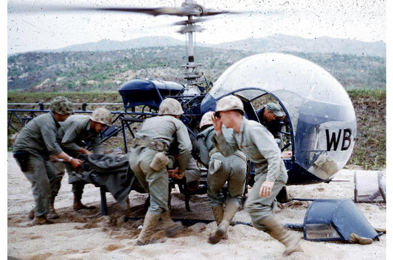A wounded servicemember is put on a helicopter in Korea in 1952.