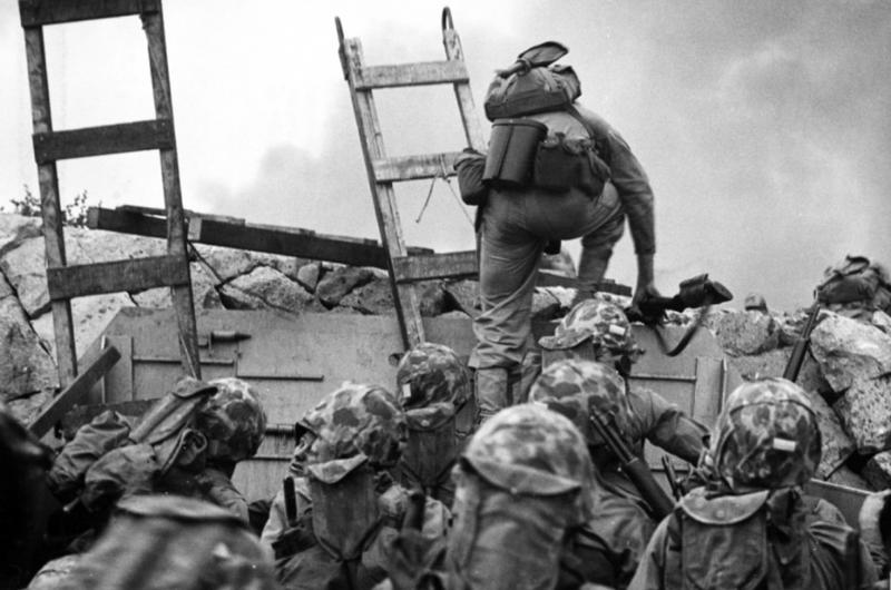 Marines climb over seawall during Incheon landing in Korean War