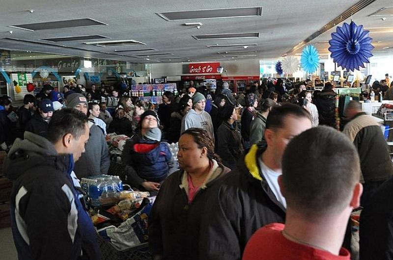 Hundreds of people crowd the Misawa Air Base commissary the day after the magnitude 9.0 earthquake rocked the region March 11, 2011, quickly emptying the shelves of batteries, water, canned food, barbecue charcoal, bread and other items.