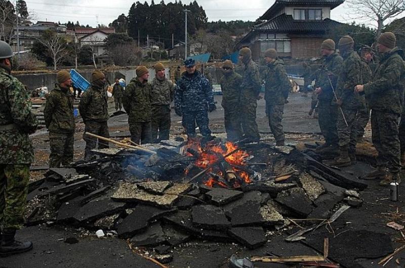 Rear Adm. Jeffrey S. Jones speaks with members of the 31st Marine Expeditionary Unit about ongoing disaster relief efforts on Oshima Island, Japan, on April 4.