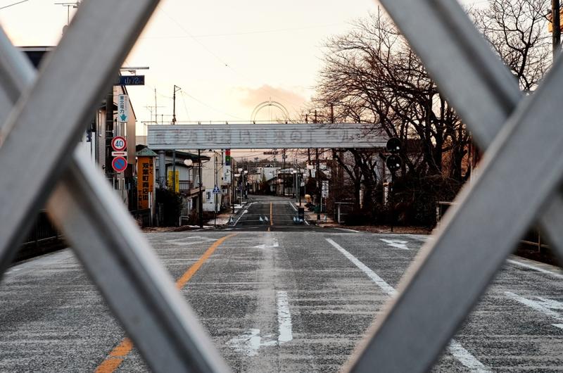 The remains of a sign reading ''Nuclear power: Energy for a bright future'' stands over the barricaded road along National Route 6 in the ghost town Futaba, Japan, less than 10 miles from the severely damaged Fukushima Dai-ichi nuclear power plant.