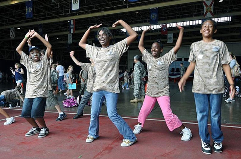 Kids perform jumping jacks while undergoing physical fitness training during Saturday's Operation CODE at Misawa Air Base, Japan.