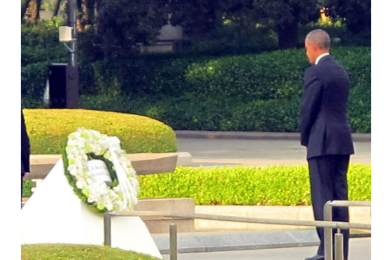 President Barack Obama stands for a moment of silence after laying a wreath at Hiroshima Peace Memorial Park on May 27, 2016.