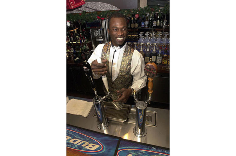 Bartender Greg Johnson pours a fresh draft behind the bar at the Embarcadero Lounge at the New Sanno Hotel in downtown Tokyo.