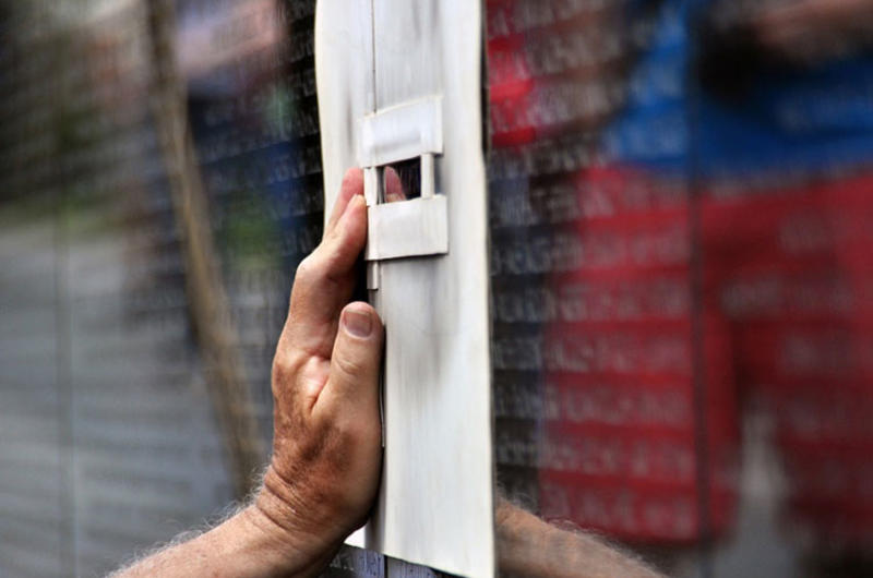 Preparing to cut another name into the black granite of the Vietnam Veterans Memorial Wall.