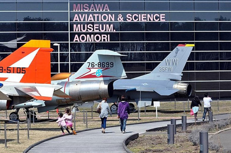 Visitors walk past a line of static display aircraft toward the entrance of the Misawa Aviation and Science Museum Aomori on April 10.