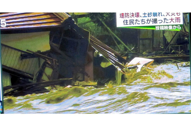 A screenshot of a TBS broadcast shows a home being destroyed by raging floodwaters in eastern Japan on Sept. 10, 2015.