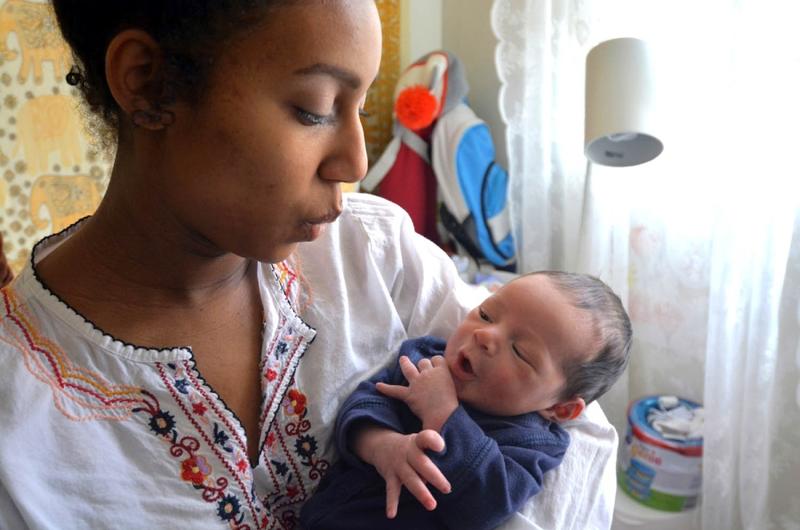 Kayla Germany, 18, holds her newborn son, Dimitri, at her home at Yokosuka Naval Base, Japan.