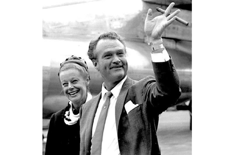 Comedian Red Skelton waves as he and his wife, Georgia, arrive in Tokyo in July, 1963.