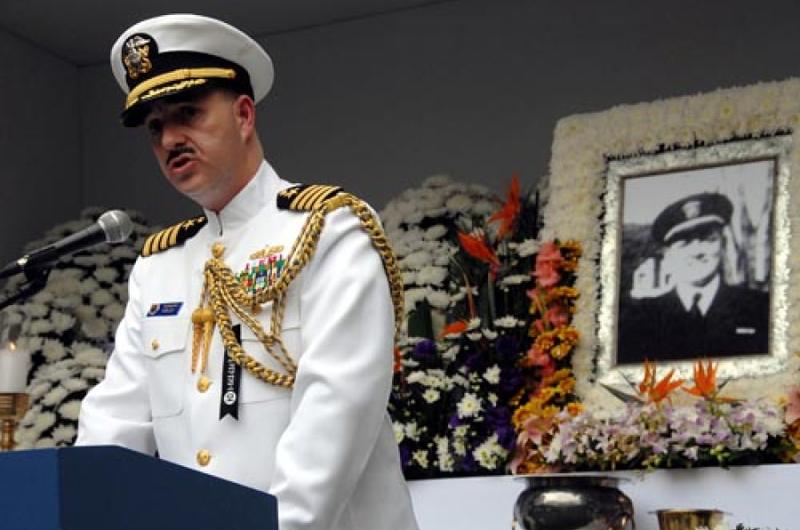 Capt. James Tranoris, Commander, Naval Forces Korea speaks in front of a photo of William Hamilton Shaw, a Korean-born U.S. Navy officer who died during the Korean War.