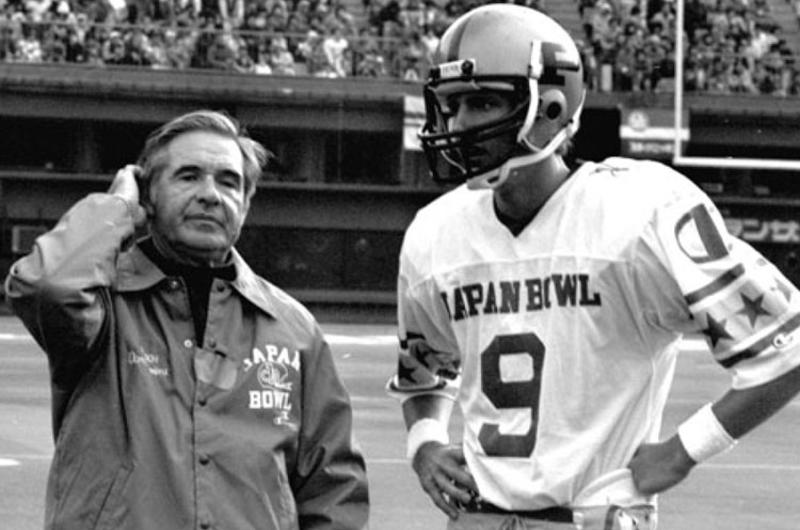 Notre Dame coach Dan Devine talks with East quarterback Mark Herrmann of Purdue during the Japan Bowl.