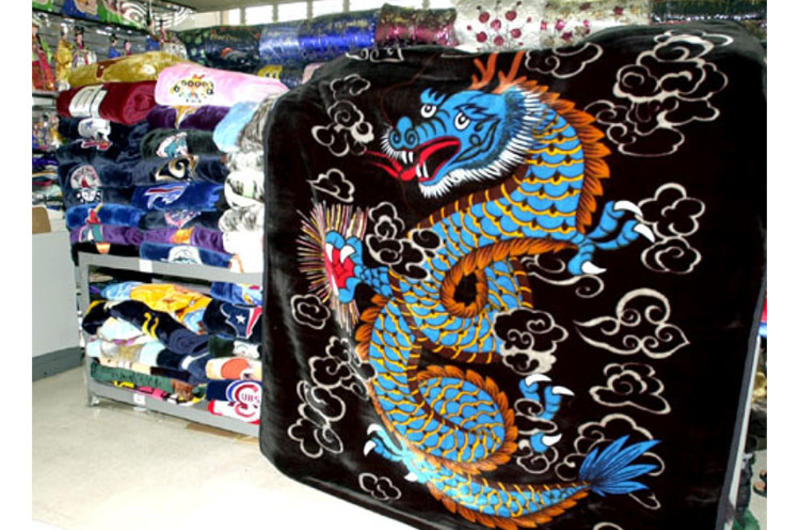 Mink blankets are among the most popular "must-have" items for those visiting or living in Korea. Here a shop has stacks of blankets in every color and design, ranging in price from $18 to $25.00.