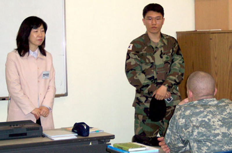 Yonsei University instructor Chun Jee-in, left, with aid from an interpreter, teaches 2nd Infantry Division soldiers about Korean language and culture at the beginning of a two-week course at the Camp Casey education center.