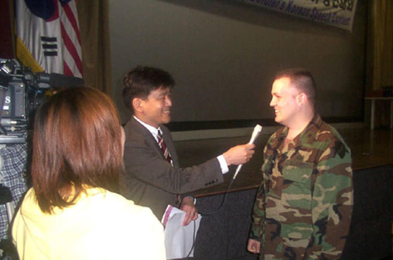 Capt. Richardson Blair IV is interviewed by Japanese television after a rousing speech that garnered him first place in the 8th annual Korean language speech contest Wednesday at Balboni Theater.