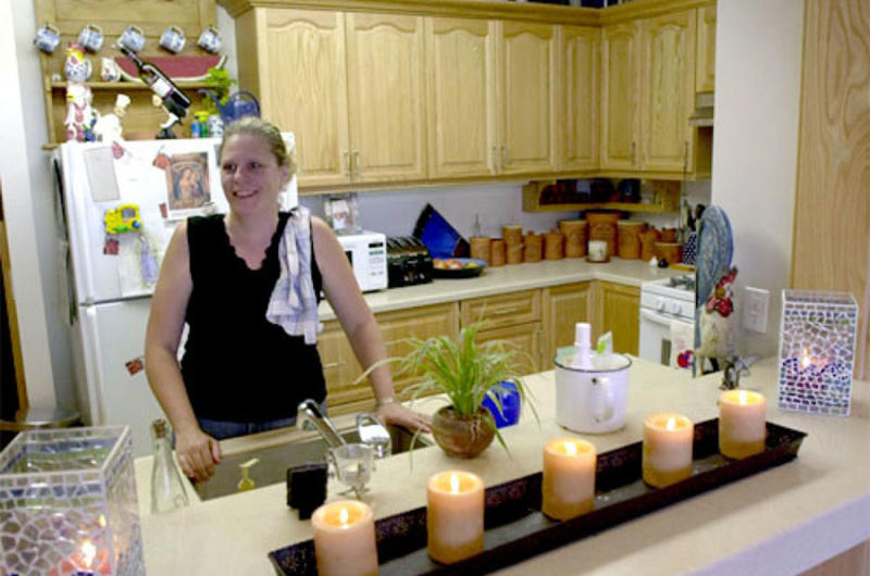 Cathy McGinn, a mother of six, stands in the kitchen of her new five-bedroom apartment in the Lloyd L. Burke Towers. Monday marked the opening ceremony for two new five-story housing towers on Yongsan Garrison’s south post.