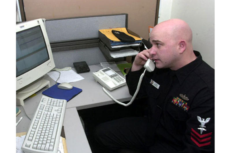 Petty Officer First Class Todd Wende reviews files in the Fleet Liason Office at Yokosuka Naval Hospital. He's in competition for the Shore Sailor of the Year award.
