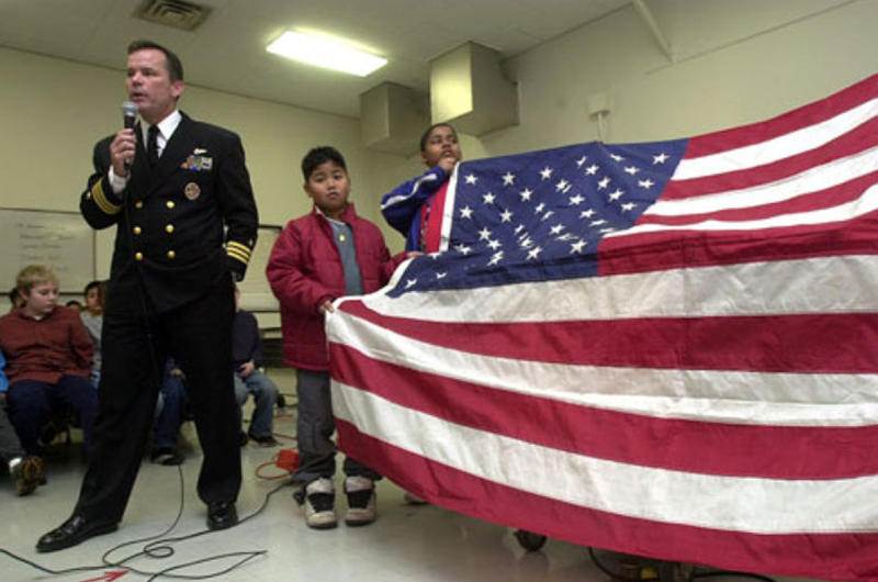Cmdr. Seamus Flatley, commanding officer of Fighter Squadron 154, talks about Old Glory, a special American flag on a world tour, Friday at Shirley Lanham Elementary School on Naval Air Facility Atsugi, Japan.